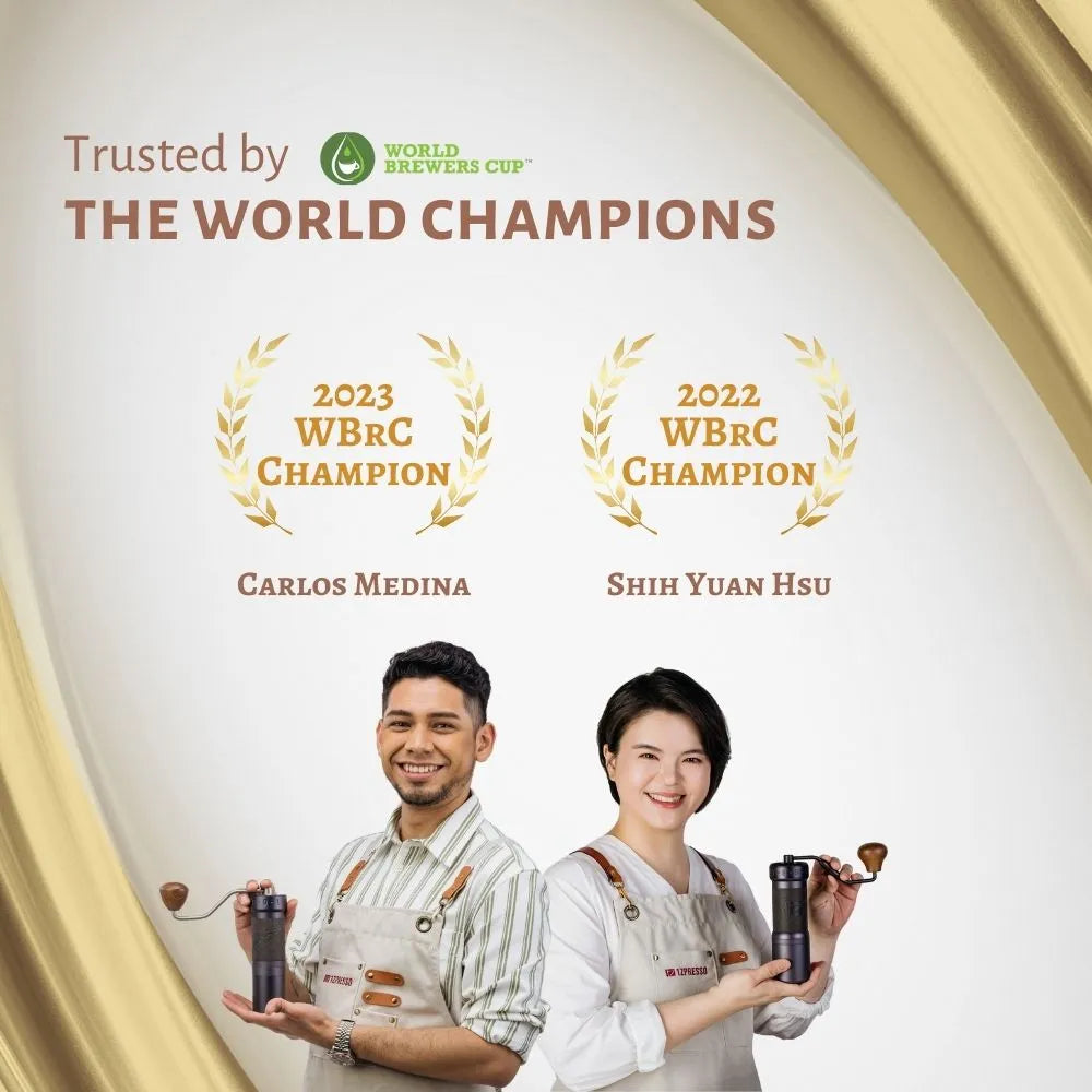 Two World Brewers Cup champions holding 1Zpresso manual coffee grinders