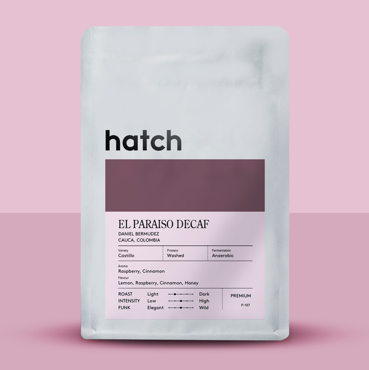Hatch decaf coffee package on a pink background