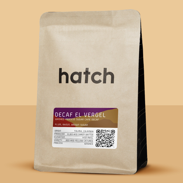 Decaf coffee bag with 'hatch' branding on a beige background