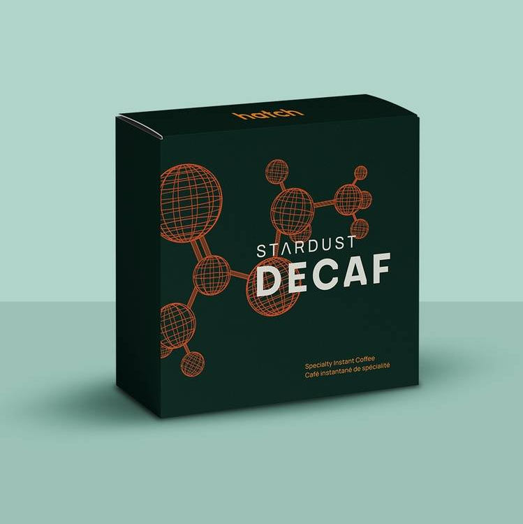 Stardust Decaf coffee packaging on a light green background
