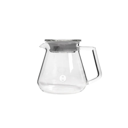 Clear glass teapot with a silver lid on a white background