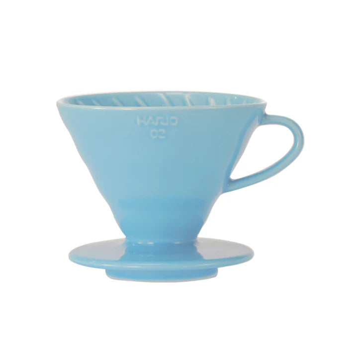 Blue ceramic coffee dripper on a white background