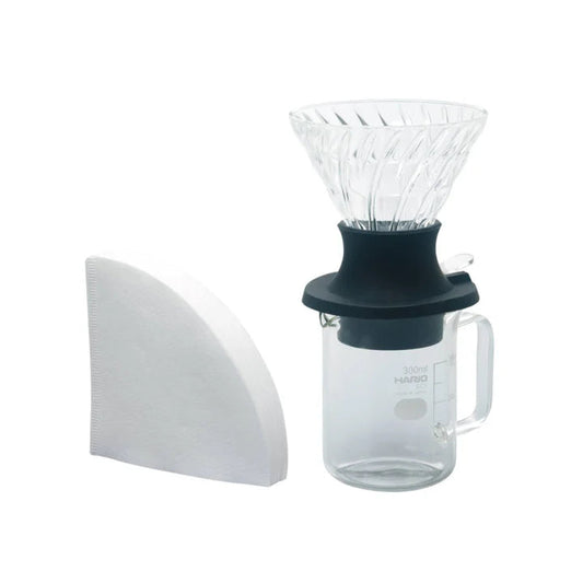 Immersion coffee brewing with a glass carafe on a white background