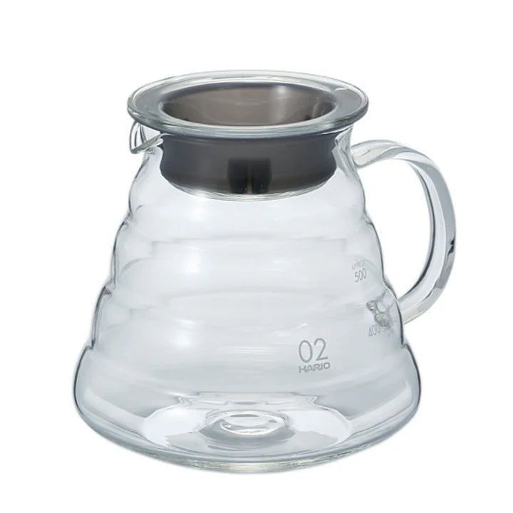 Clear glass coffee server with metal lid on a white background