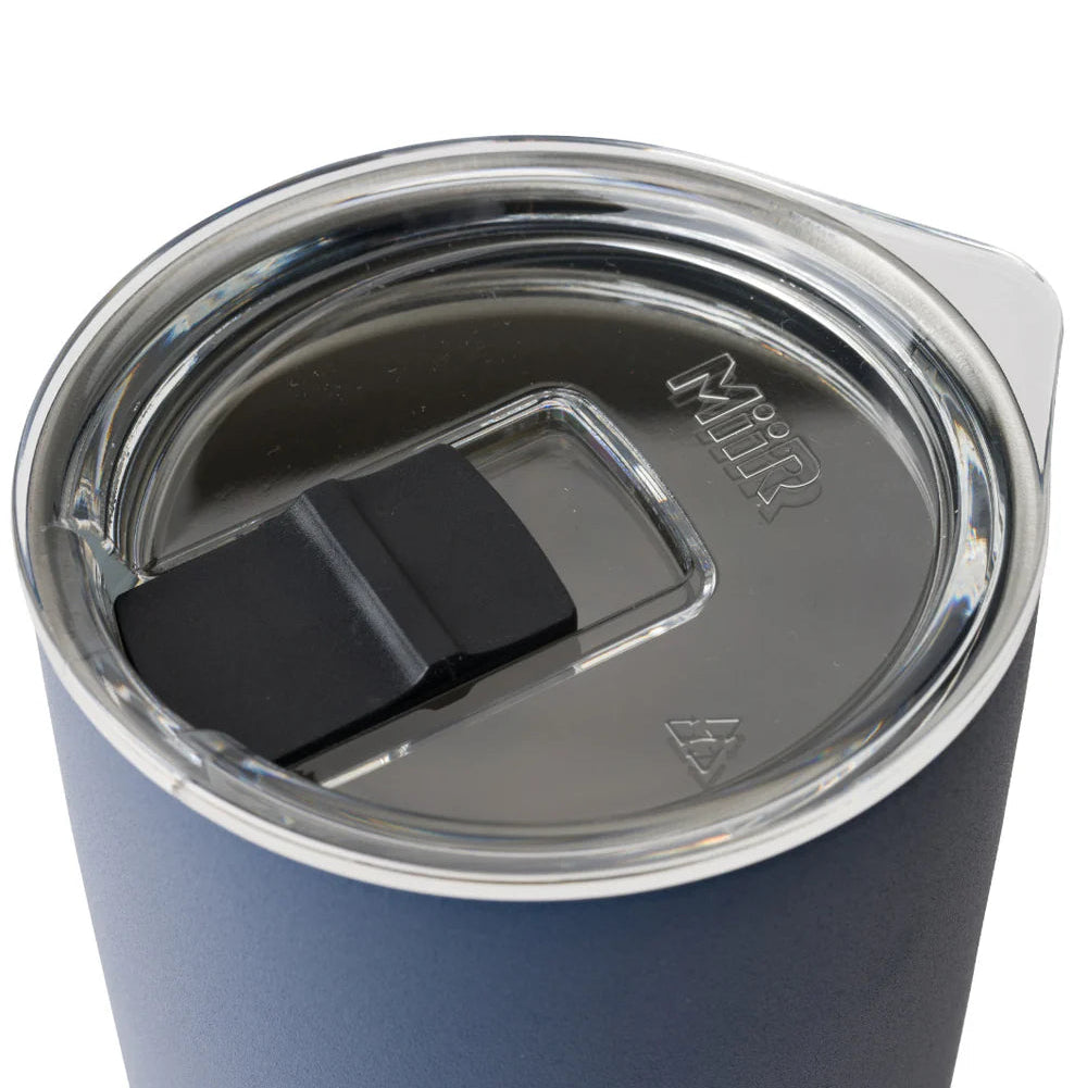 Blue tumbler with a clear lid on a white background